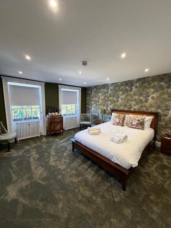 a bedroom with a large bed and a stone wall at Kip 54 Monks Bar in Portsmouth