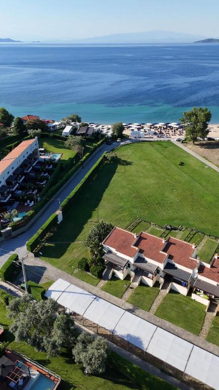 an aerial view of a house with the ocean in the background at Azure Residence Koumitsa in Nea Roda