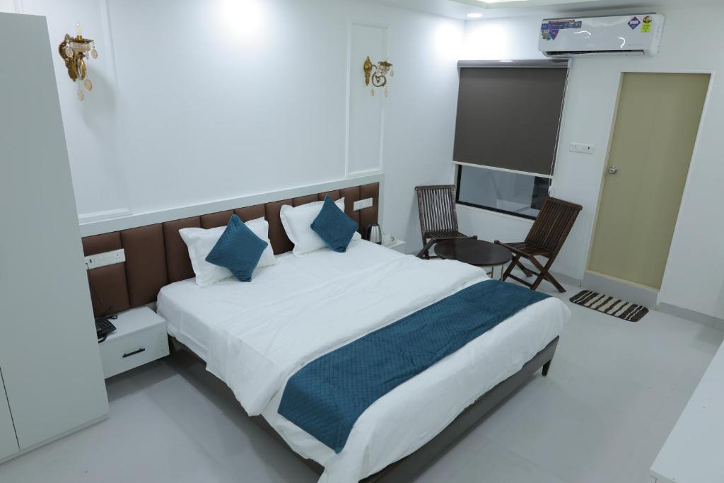 a bedroom with a large bed and a television at Hotel Ashok Vatika in Māharjhari