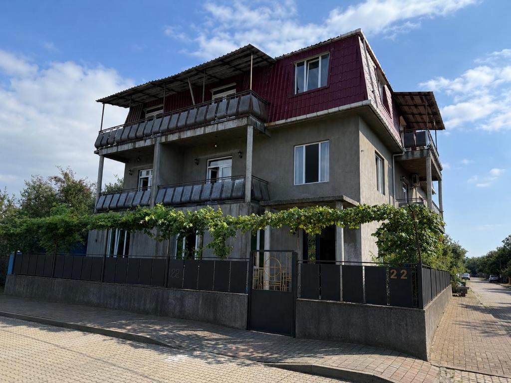a building with a fence in front of it at Mziuri Cozy Guesthouse in Kobuleti