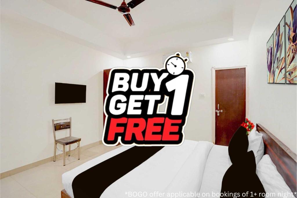 a bedroom with a bed with a buy get free sign at Super Collection O Friends Colony Lucknow Formerly The Suite in Lucknow