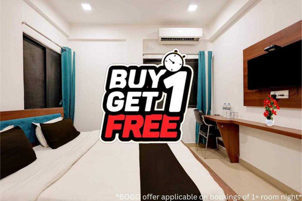a bedroom with a bed with a buy get free sign at Super Collection O Besa Square Nagpur Formerly Yuva Inn in Nagpur