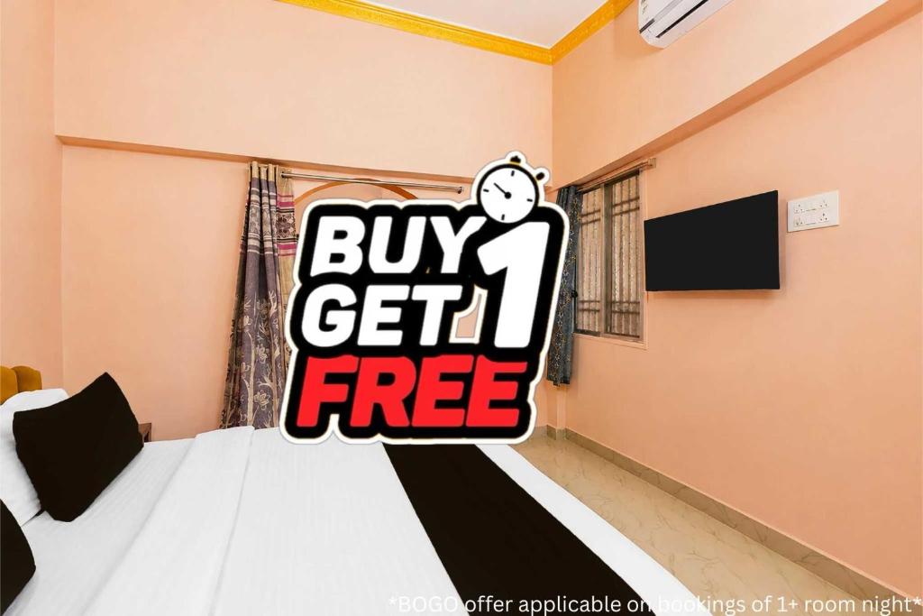 a bedroom with a buy get free sign on the bed at Hotel O AIIMS Raipur in Raipur