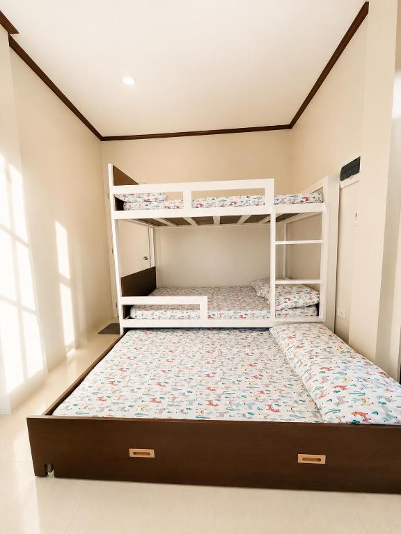 a bedroom with two bunk beds in a room at Gloria's Home Stay in Oslob