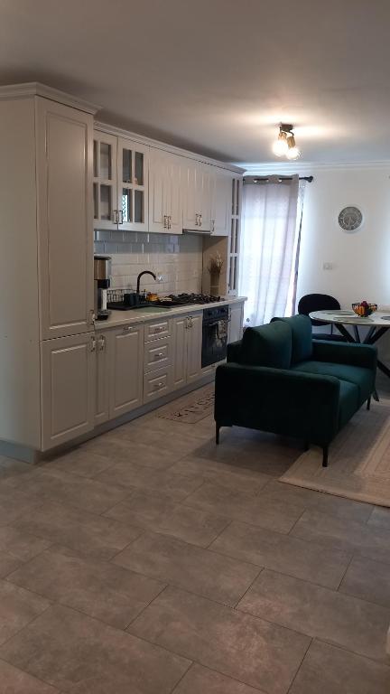 a living room with a couch and a kitchen at Casa A&A Stefan Livada in Livada