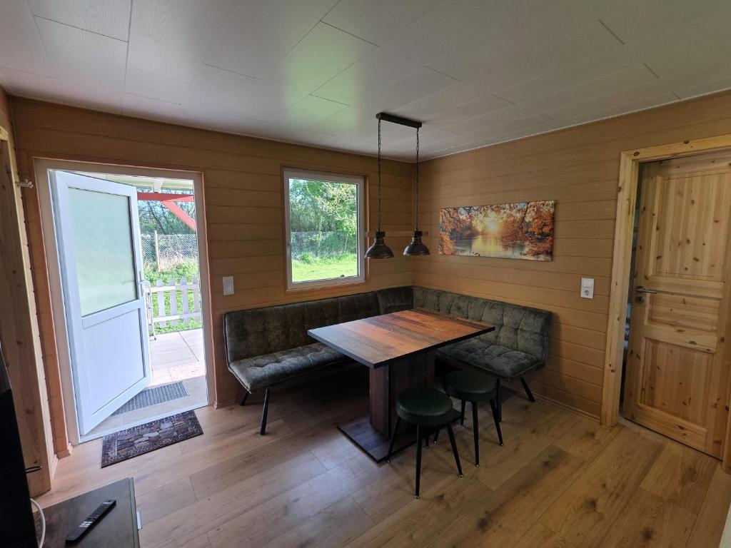 a room with a table and chairs and a window at Bungalow Seedorf 9 in Basedow