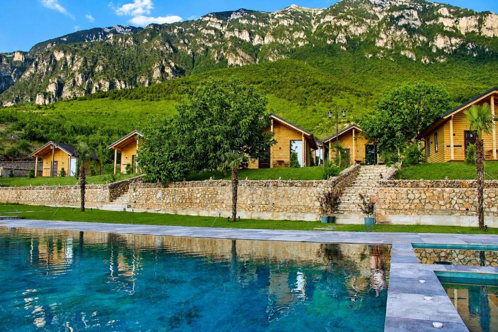 a row of houses in front of a mountain at Bujtina Kapinova in Berat