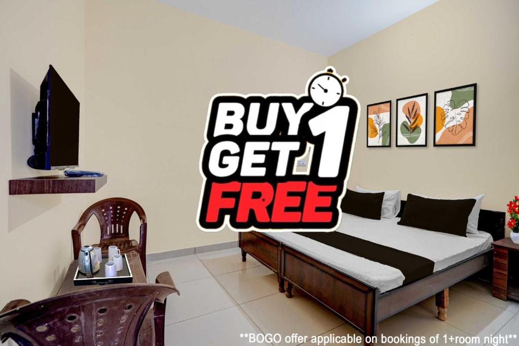 a bed with a buy get free sign in a room at Hotel O Chandigarh Outer Ring Road Formerly Ganesha in Chandīgarh