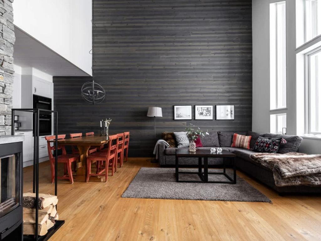 a living room with a couch and a table at Spacious Slopeside Home with Sauna in Åre