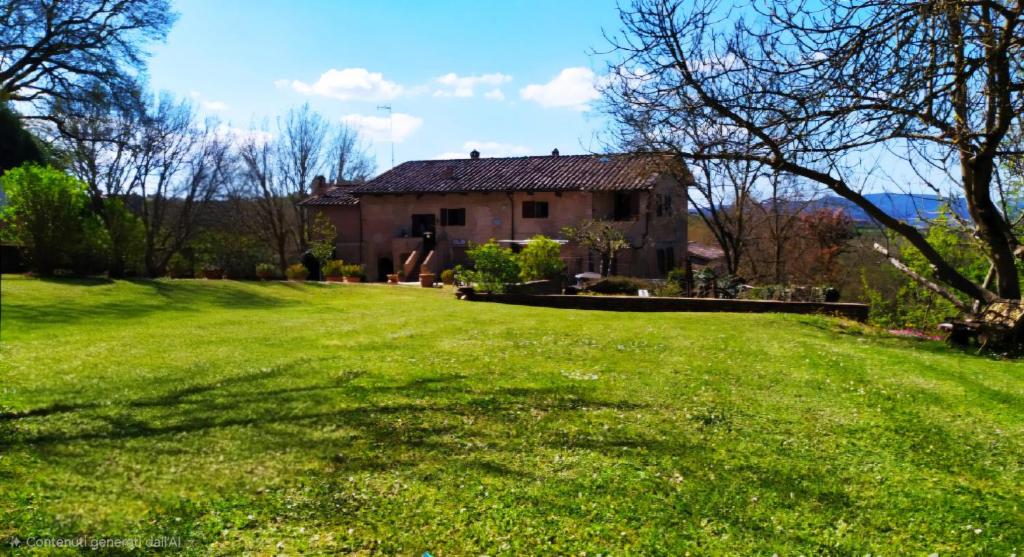 an old house with a large grass yard at Da Taz Siena in Siena