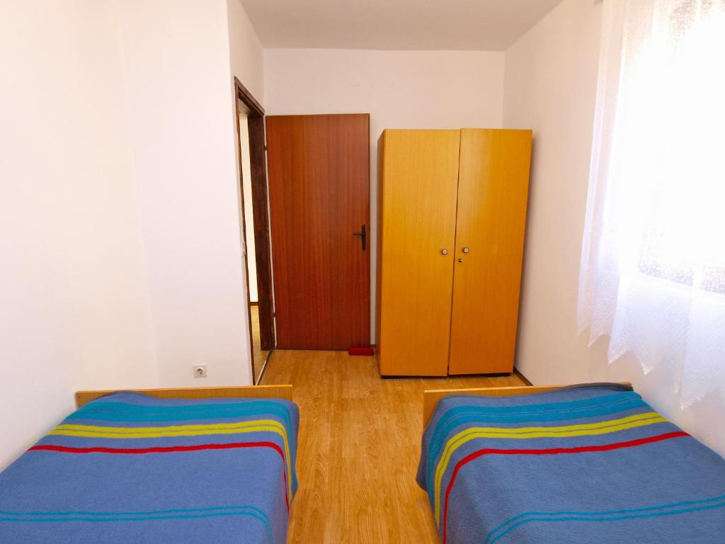 Łóżko lub łóżka w pokoju w obiekcie Apartments Biskupije 940