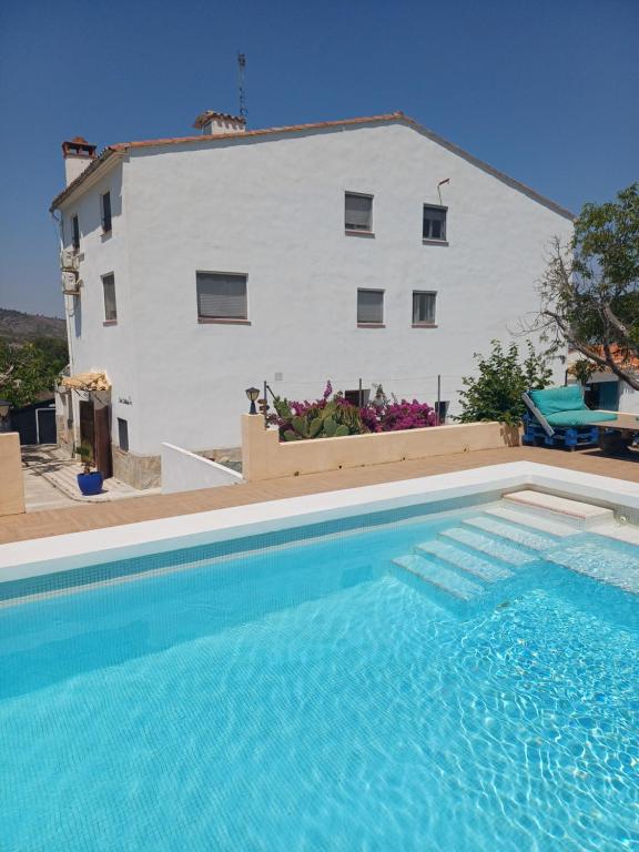 a large swimming pool in front of a house at B&B Casa Vitalidad in Ontinyent