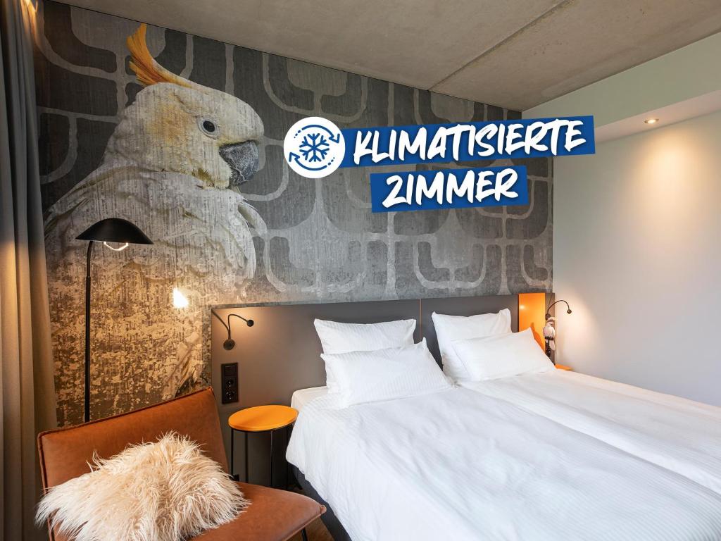 a hotel room with a bed and a sign at LOGINN Hotel Waiblingen in Waiblingen