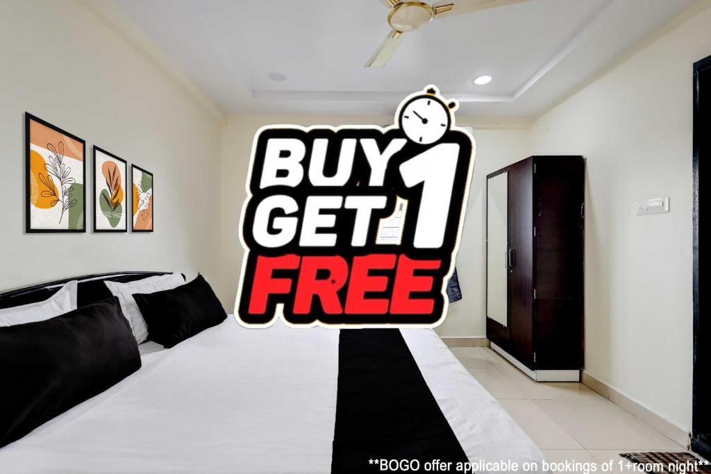 a bedroom with a buy get free sign on the wall at Hotel O Satyam Junction Seethammadhara in Visakhapatnam