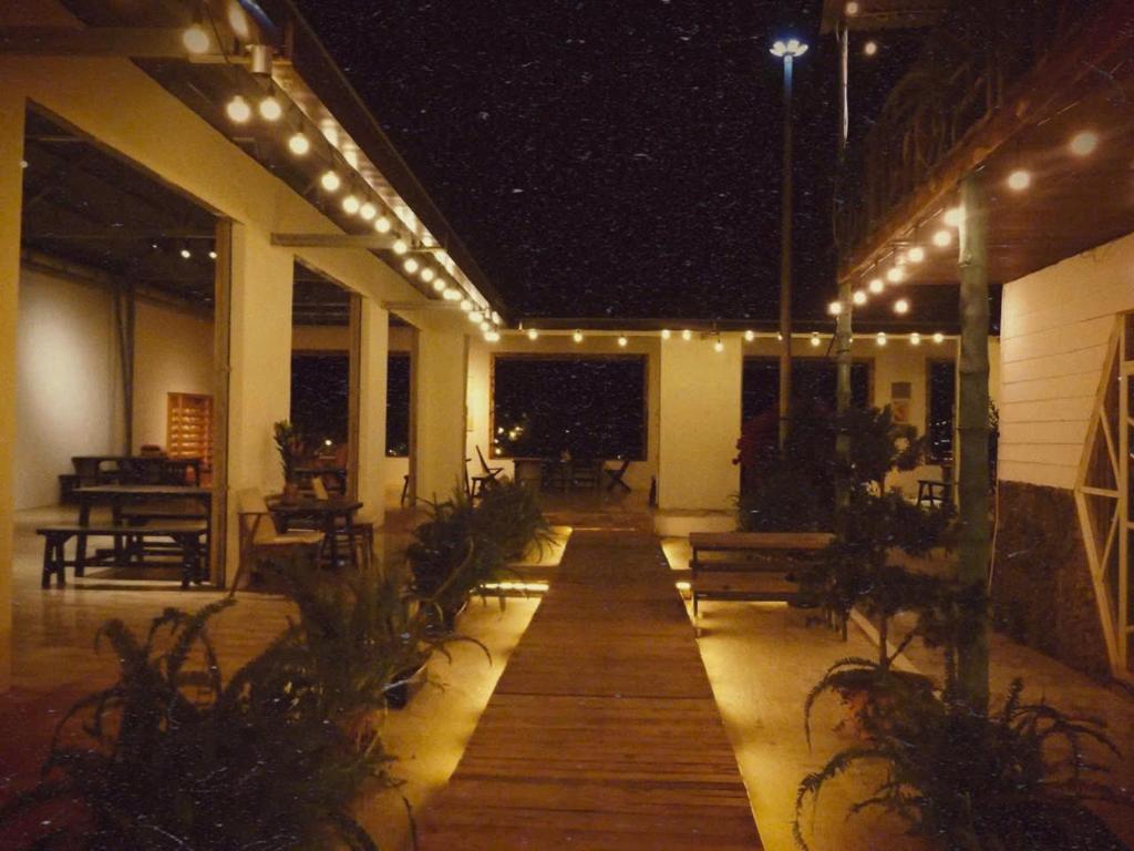 a patio with lights and benches at night at Hoa Rừng Homestay in Xuan An