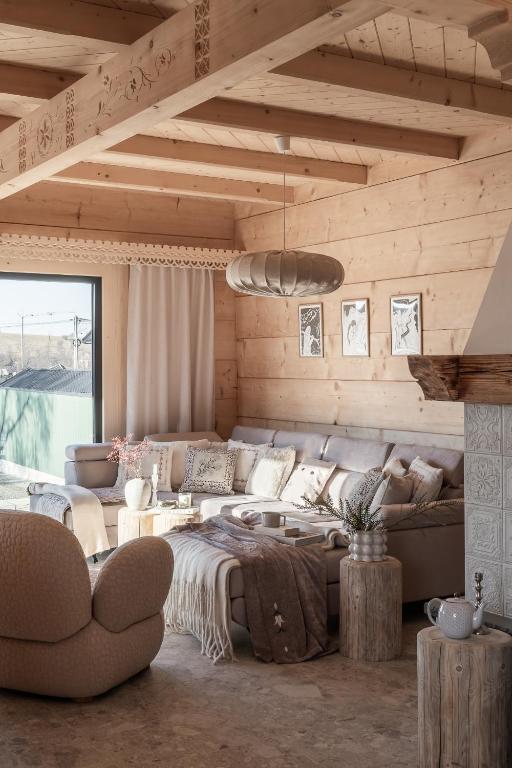 a living room with a large bed and a couch at Ziębowe Ranczo in Chochołów