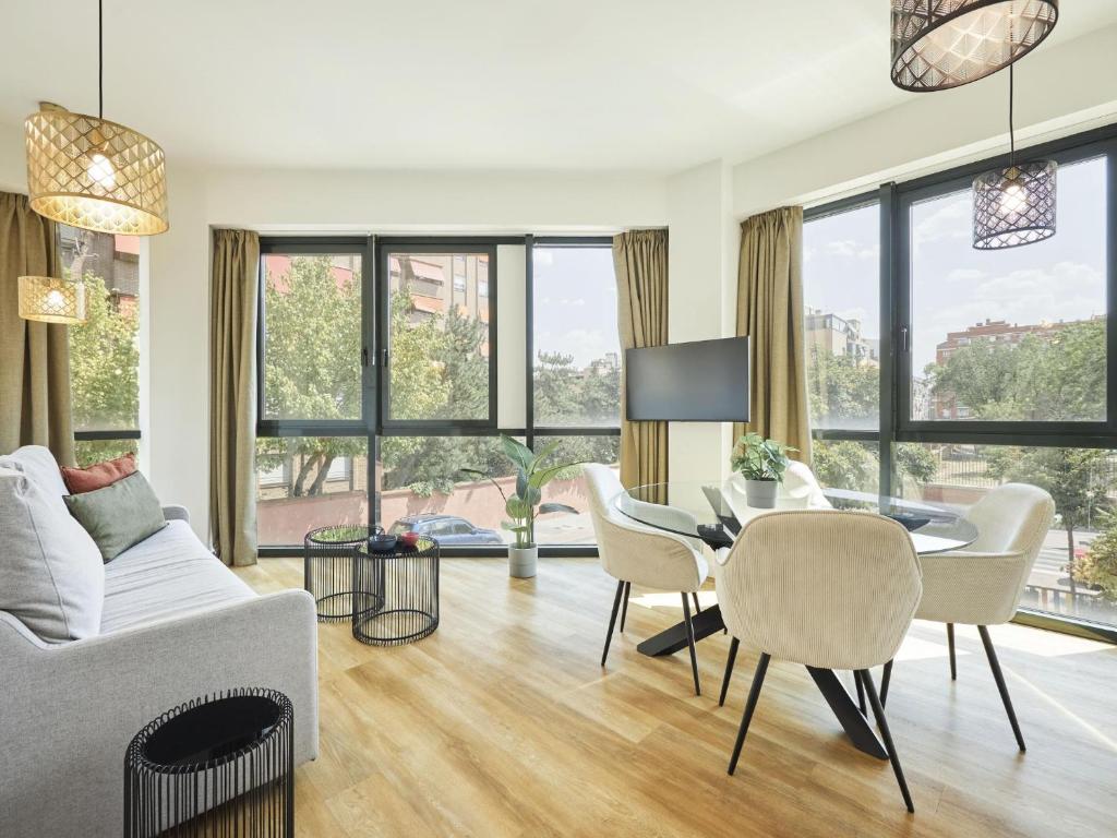 a living room with a couch and chairs and a table at Catalina Retiro Madrid in Madrid