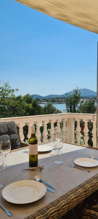 a table with glasses and a bottle of wine at Villa Nikki in Bilice