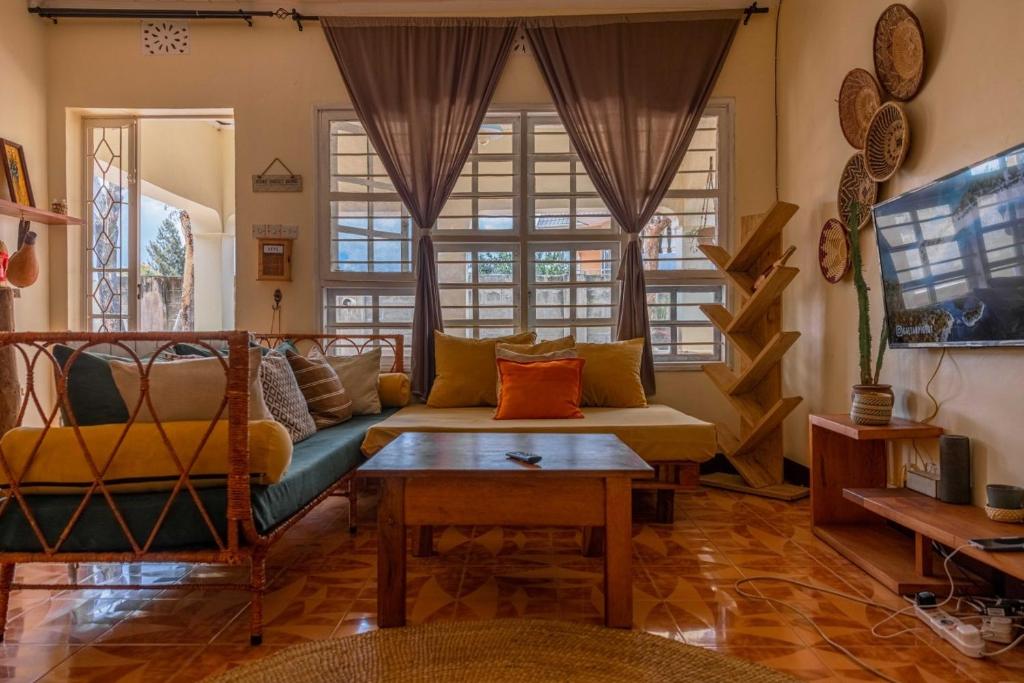 a living room with a couch and a table at Utamaduni House B&B in Arusha