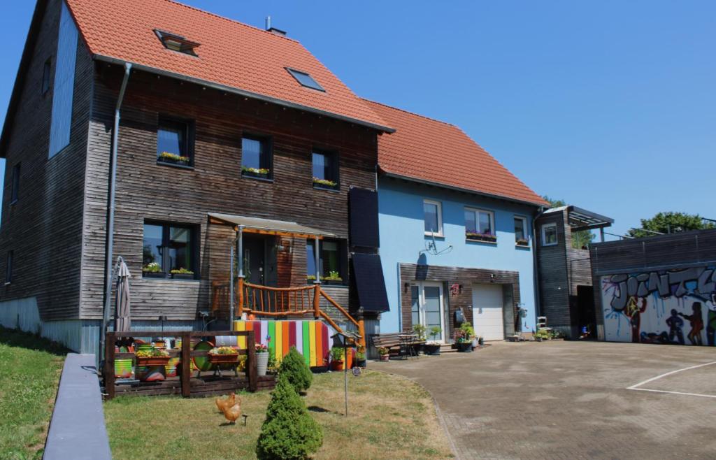 a house with a basketball court in front of it at Etappe 17 - am Kylltal Radweg in Birgel