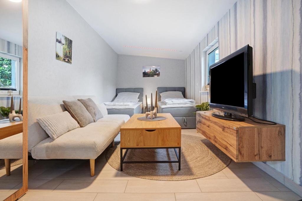 a living room with a couch and a tv at Fewo Gustav Melkert Str. 5A in Röbel