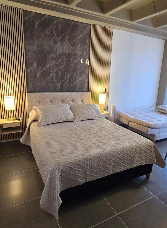 a bedroom with a large bed with a large headboard at apartamento tipo loft en sabaneta in Sabaneta