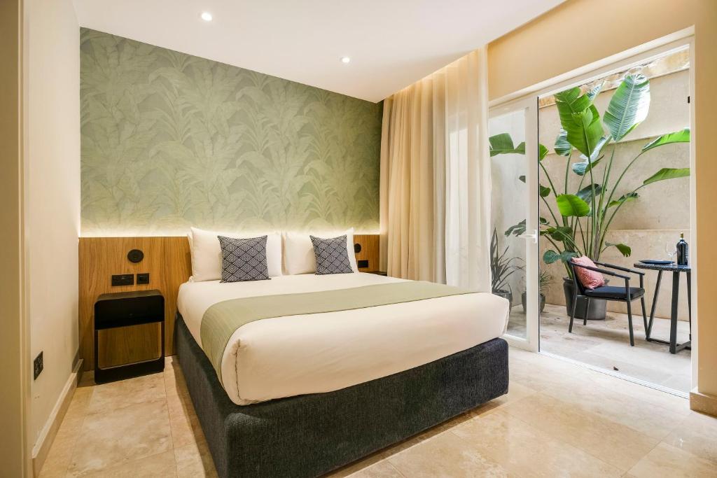 a bedroom with a large bed in a room at The Three Doors in St. Julianʼs