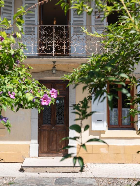 a house with a wooden door and a balcony at maison savoyarde in Doussard