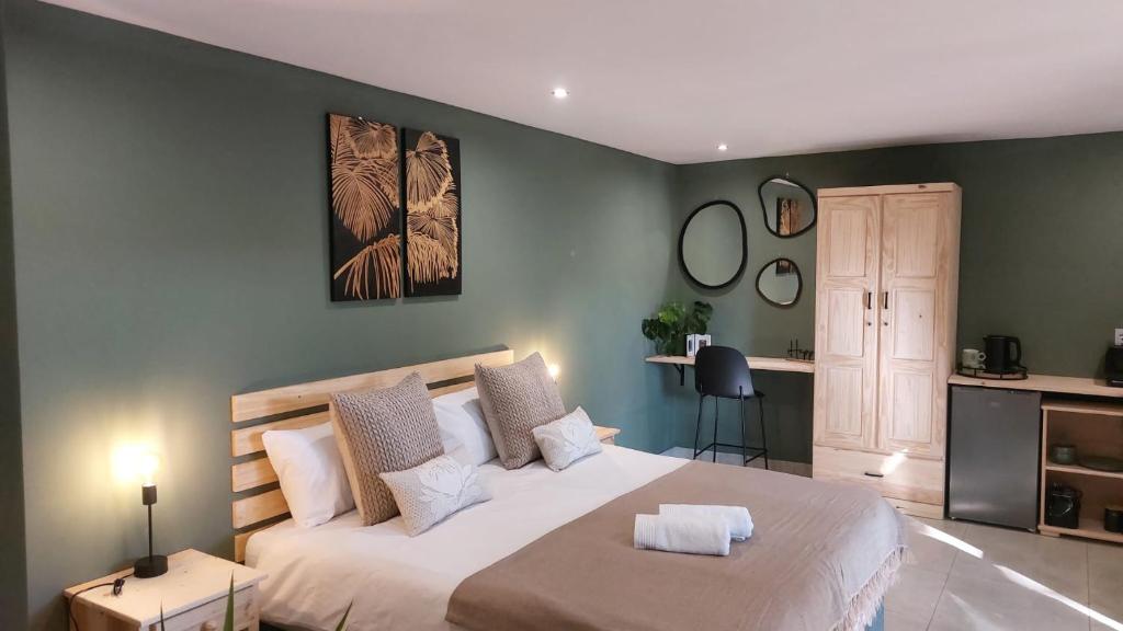 a bedroom with a large bed in a room at Guesthouse Charis in Pretoria