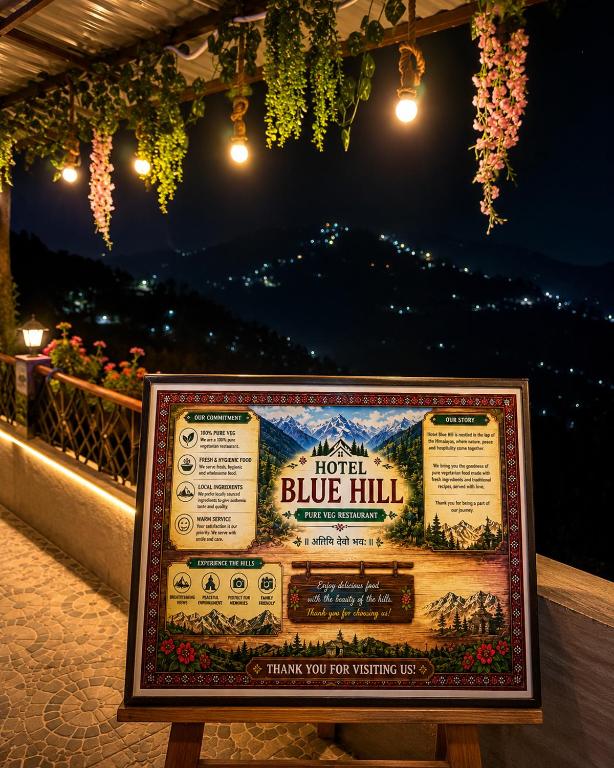 a sign for a blue hill train station at night at Hotel Blue Hill in Chamba