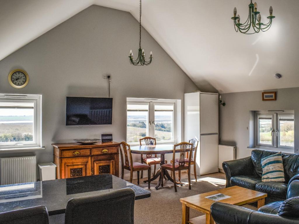 a living room with a couch and a table and chairs at Holly No2 - Uk49254 in Althorne