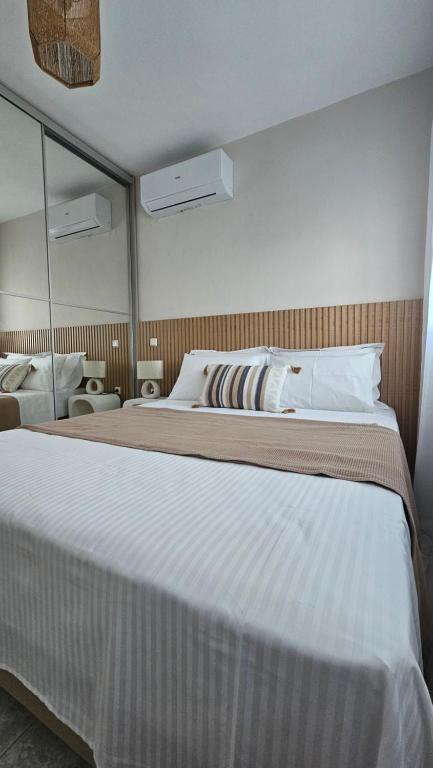 a bedroom with a large bed and a large mirror at Carte Postale Trikeri in Trikeri