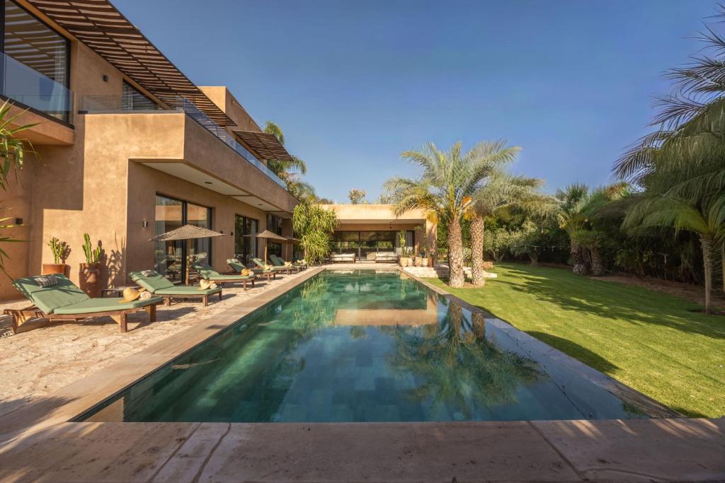 a swimming pool in the backyard of a house at Palais Nohe in Marrakesh