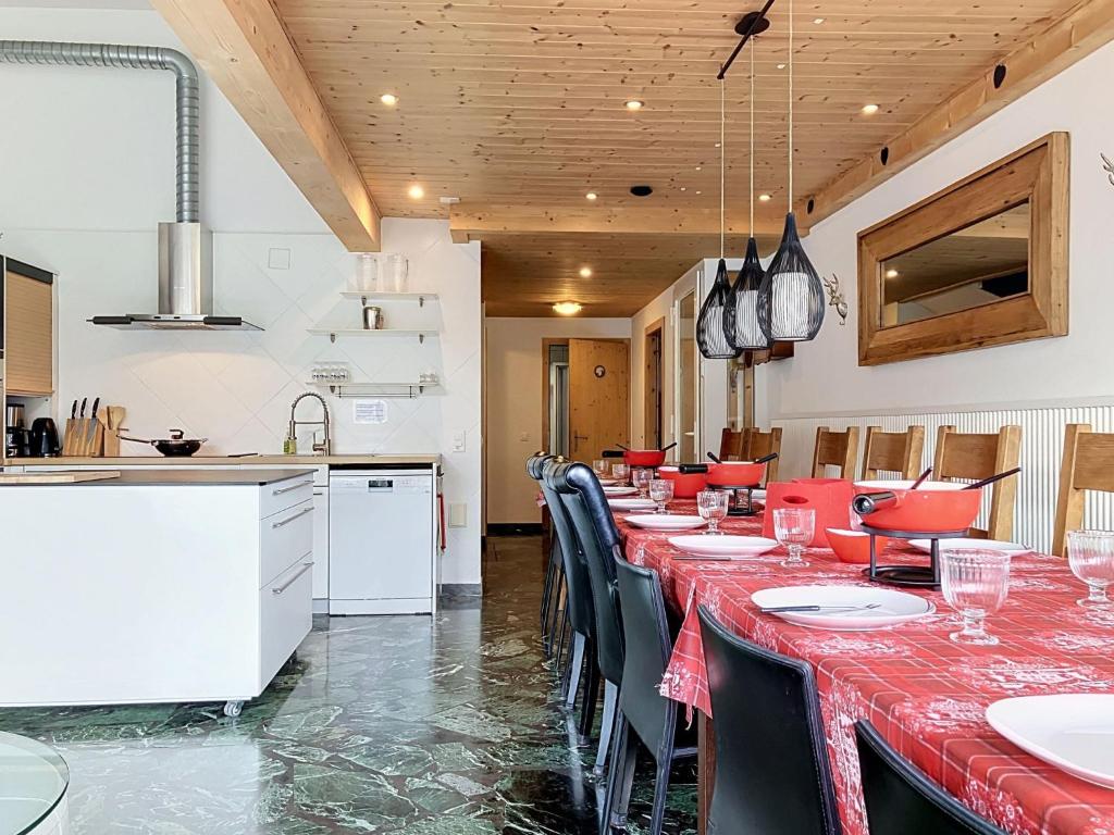 a dining room with a long table and chairs at Apartment Les Cimes by Interhome in Les Crosets
