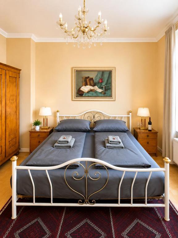 a bedroom with a bed and a chandelier at Velmora Boutique Suites - Vintage Design Apartment in Altstadtnähe in Lübeck