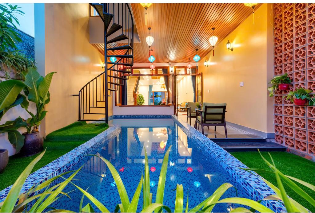 a house with a swimming pool in the middle of a house at An Bang Chic Villa Nguyên Căn in Tân Thành (1)