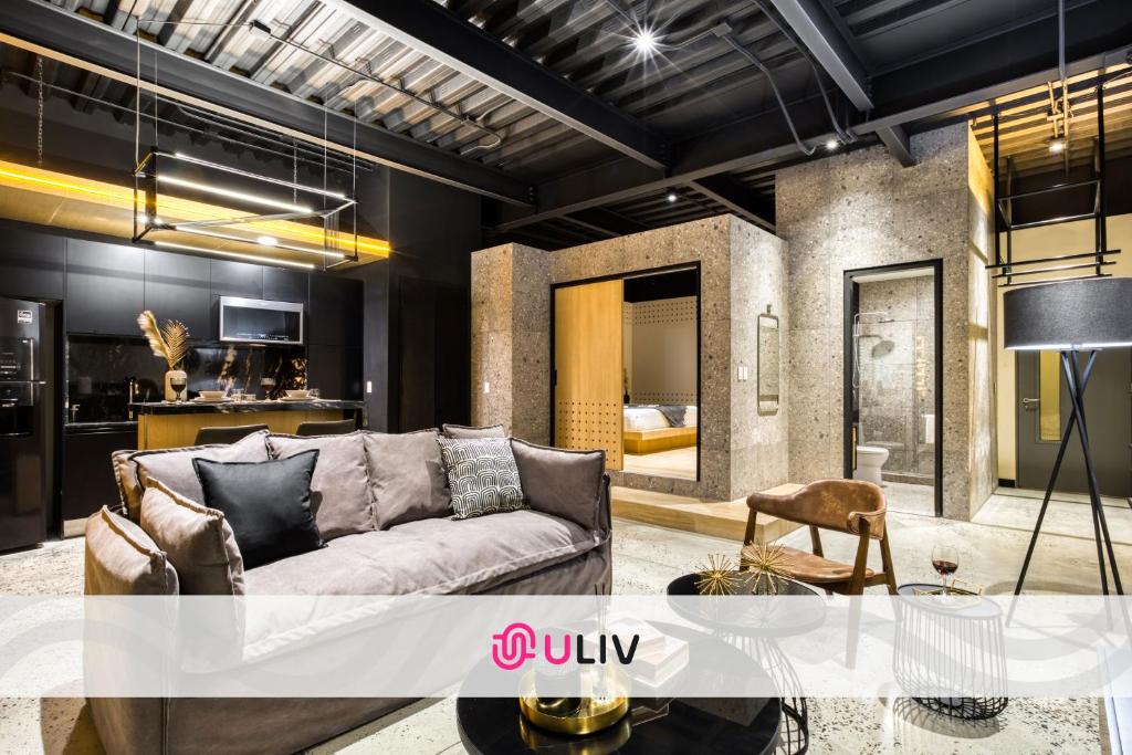 a living room with a couch and a table at Downtown Designer Apartments by ULIV in Tijuana