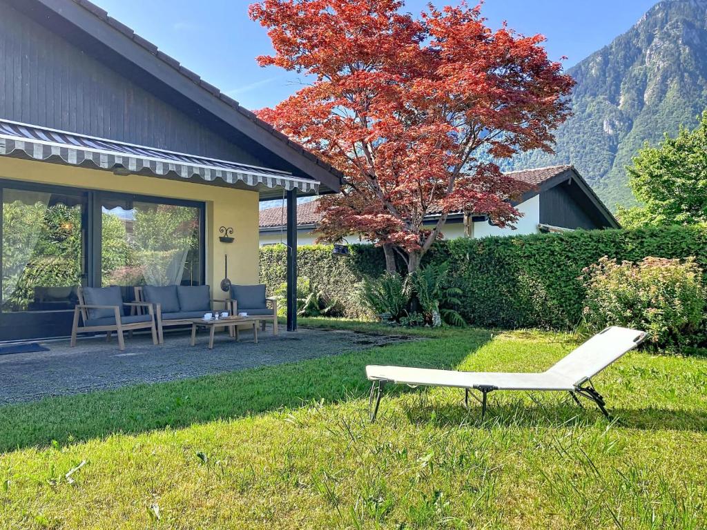 a white bench sitting in the grass next to a house at Holiday Home Dorenavant by Interhome in Bouveret