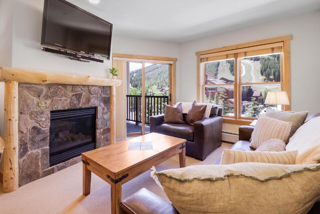 a living room with a fireplace and a tv at CS334 Copper Springs in Copper Mountain