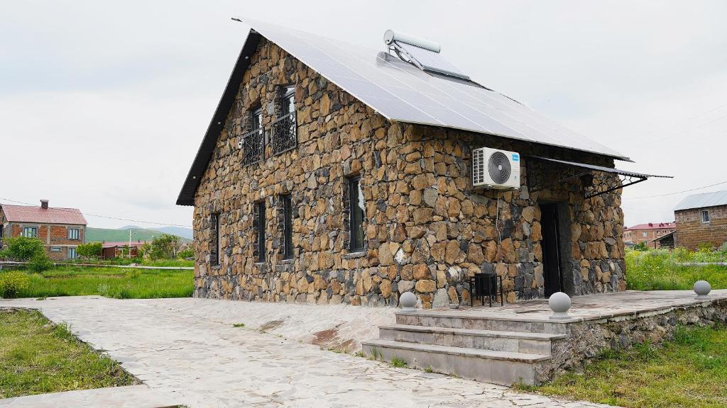 a stone building with a speaker on top of it at Jermuk garden in Kechʼut