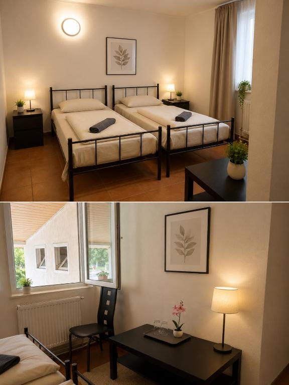 a bedroom with two beds and a table in a room at Cabana Lir in Arad