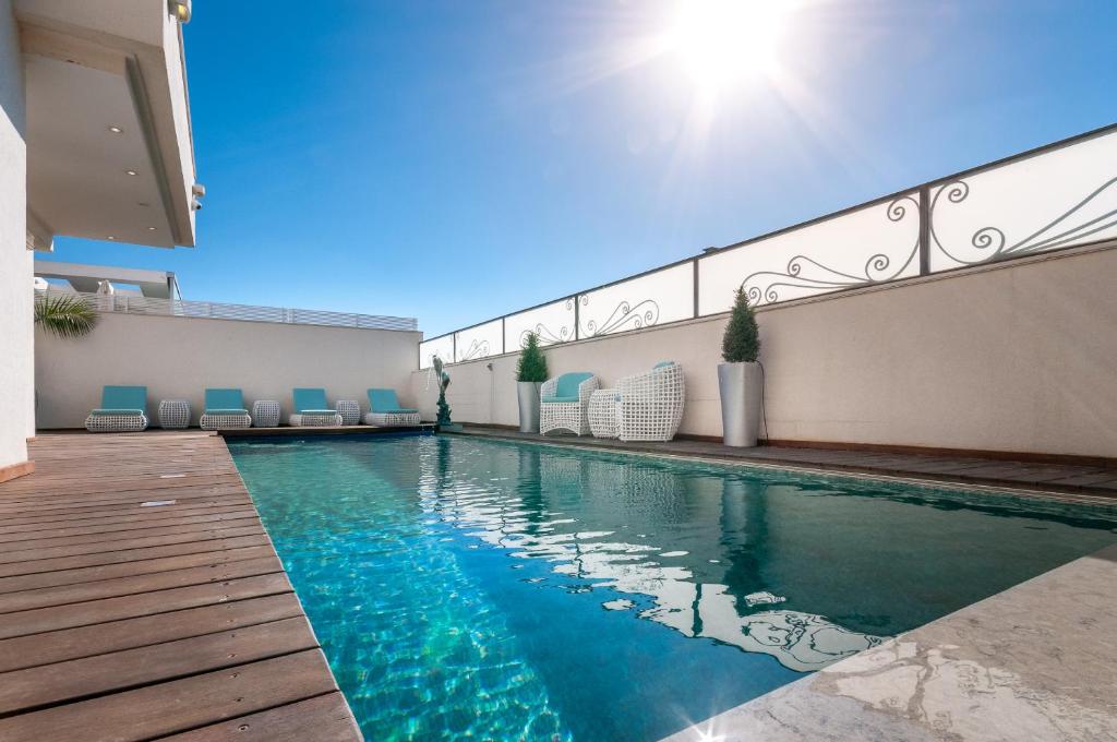 a swimming pool in the middle of a house at Cosytal Villa in Herzliya