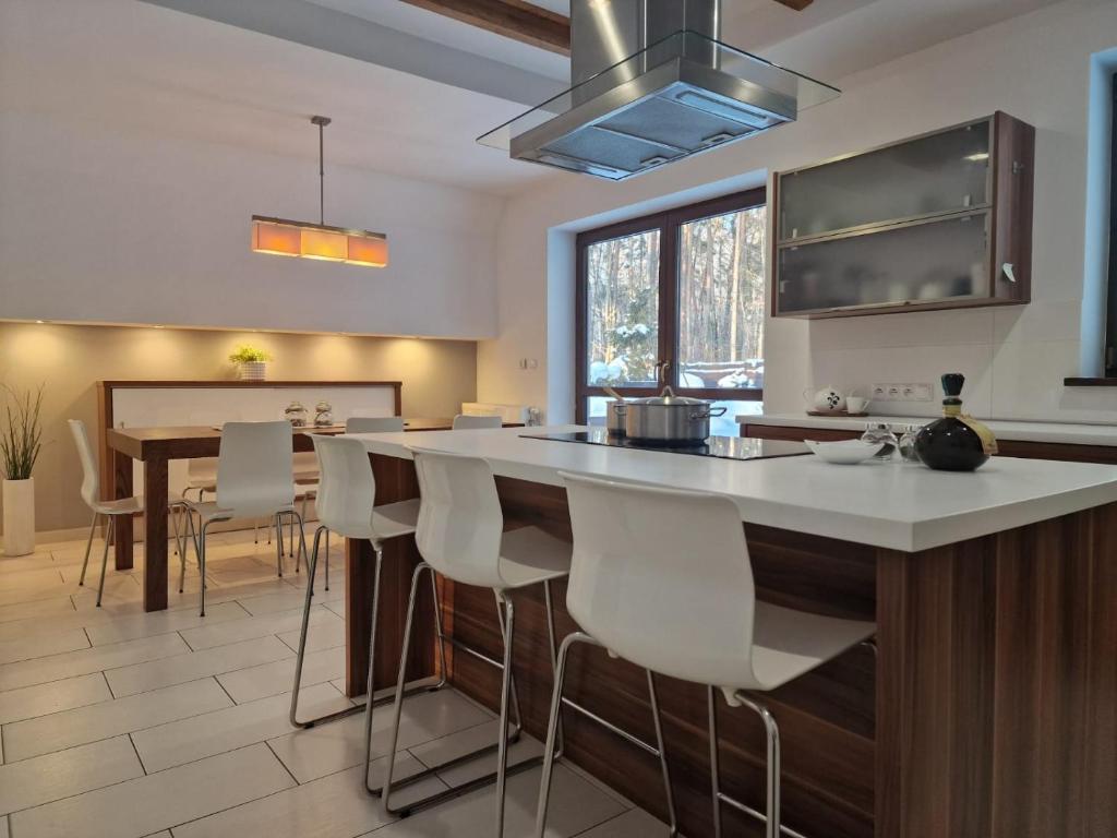 a kitchen with a large island with white counter tops at InOut Dom Olsztyn in Olsztyn