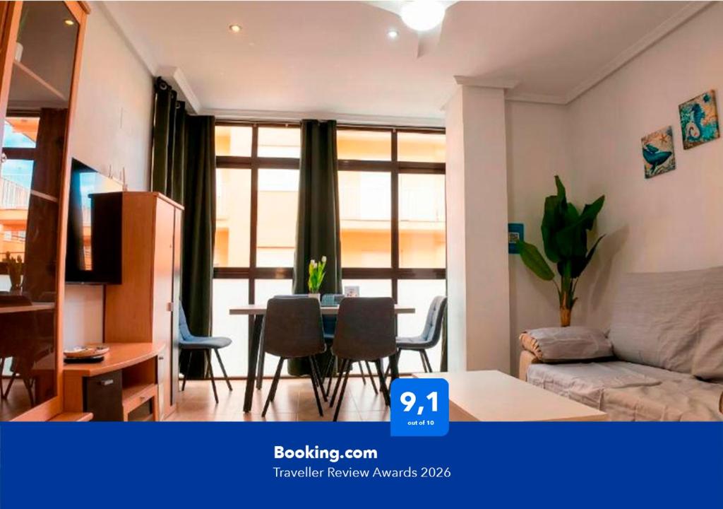a living room with a table and a couch at Apartalux San Pedro Playa in San Pedro del Pinatar