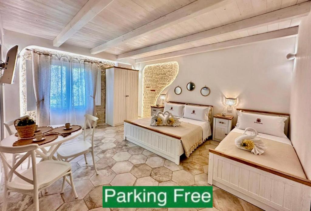a bedroom with two beds and a table and a tableasteryasteryasteryasteryastery at Godano Rooms in Drapia