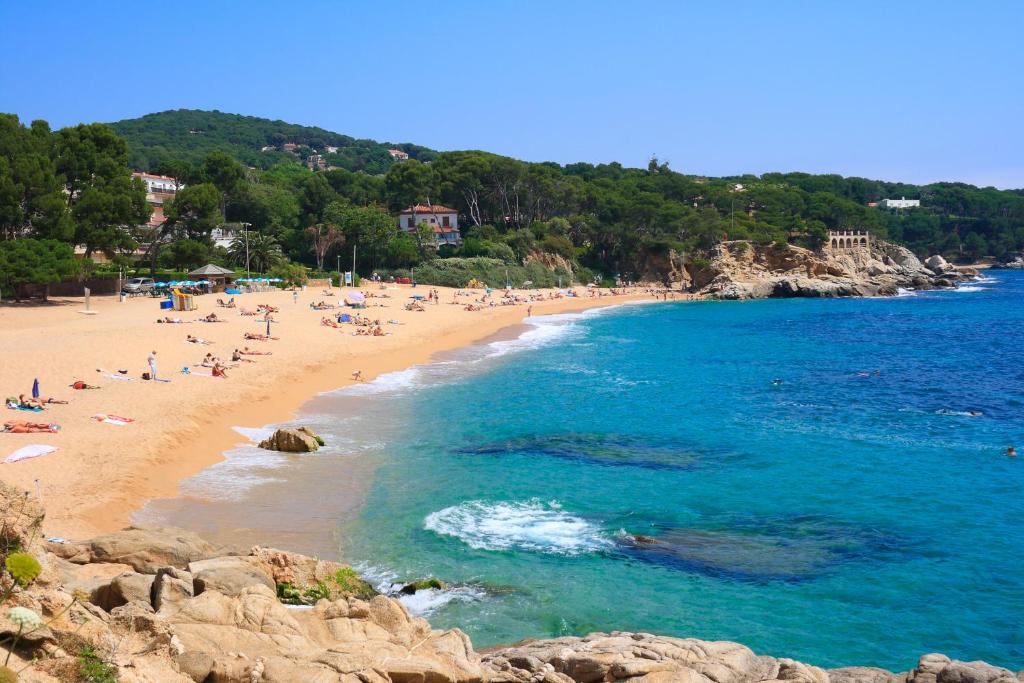 a group of people on a beach near the water at Kampaoh Platja d'Aro in Platja d'Aro