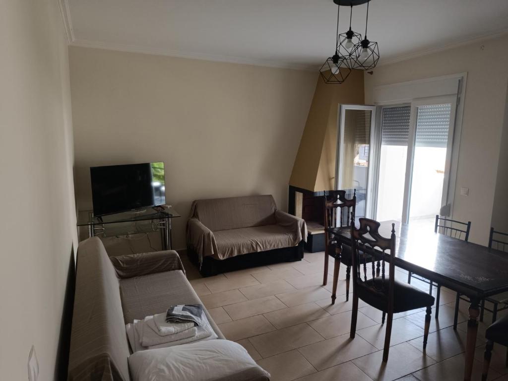 a living room with a couch and a table at Aphroditi Luxury Vila in Chrysi Ammoudia