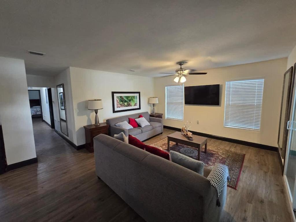 a living room with a couch and a tv at 2Bed 2Bath Lake Front Jewel in Lake Mary