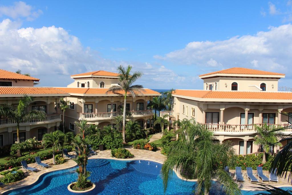 an aerial view of a resort with a swimming pool at The Meridian at Lighthouse Point in West Bay