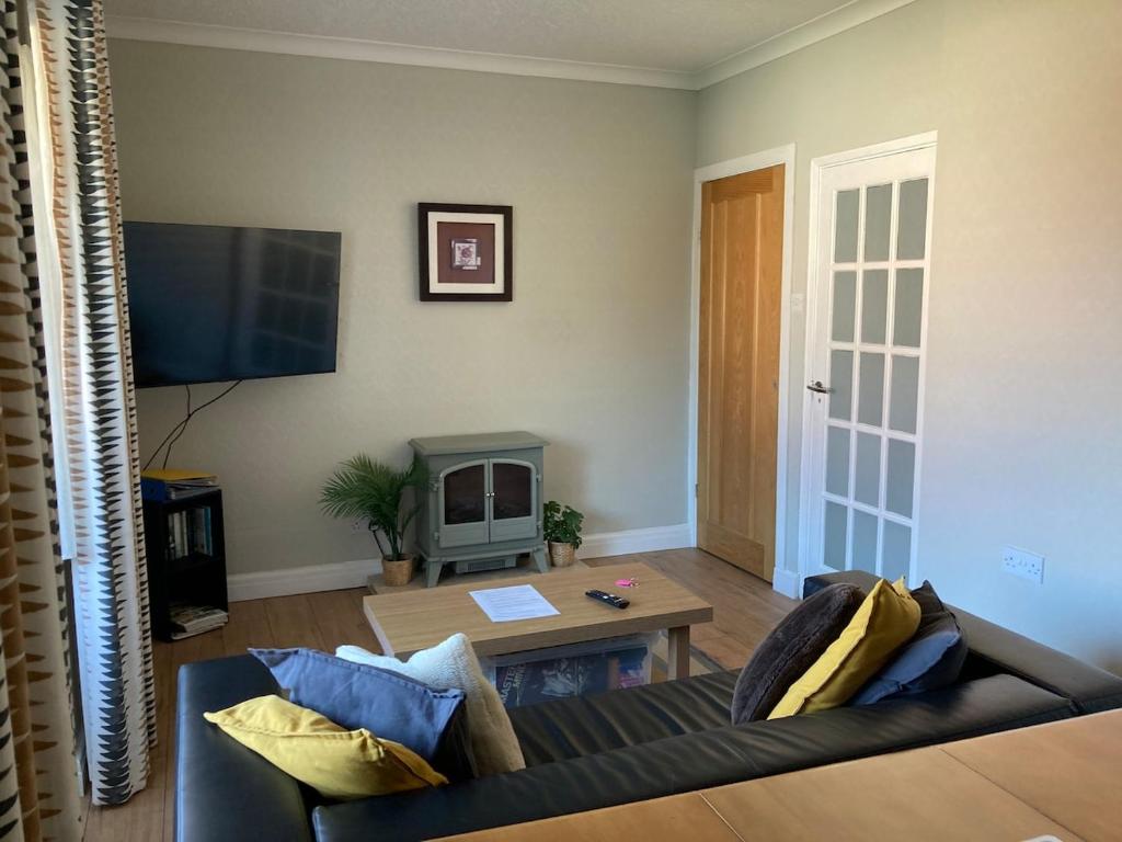 a living room with a couch and a table at Fairways in Cleveleys